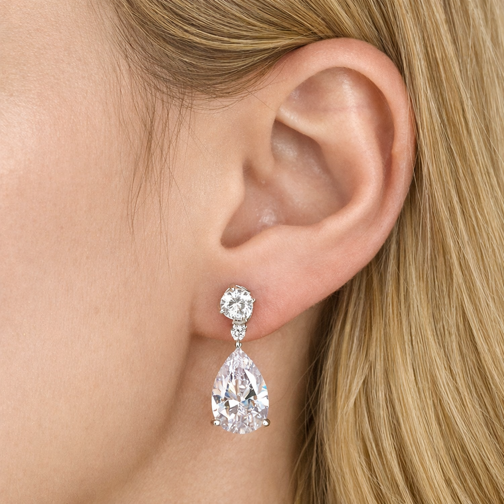 woman wearing ciela silver pear cut drop earrings by revert