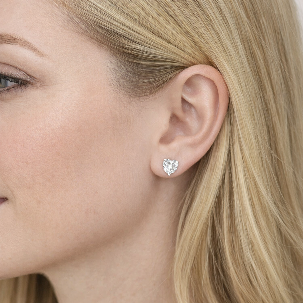 woman wearing eira silver heart cut stud earrings by revert