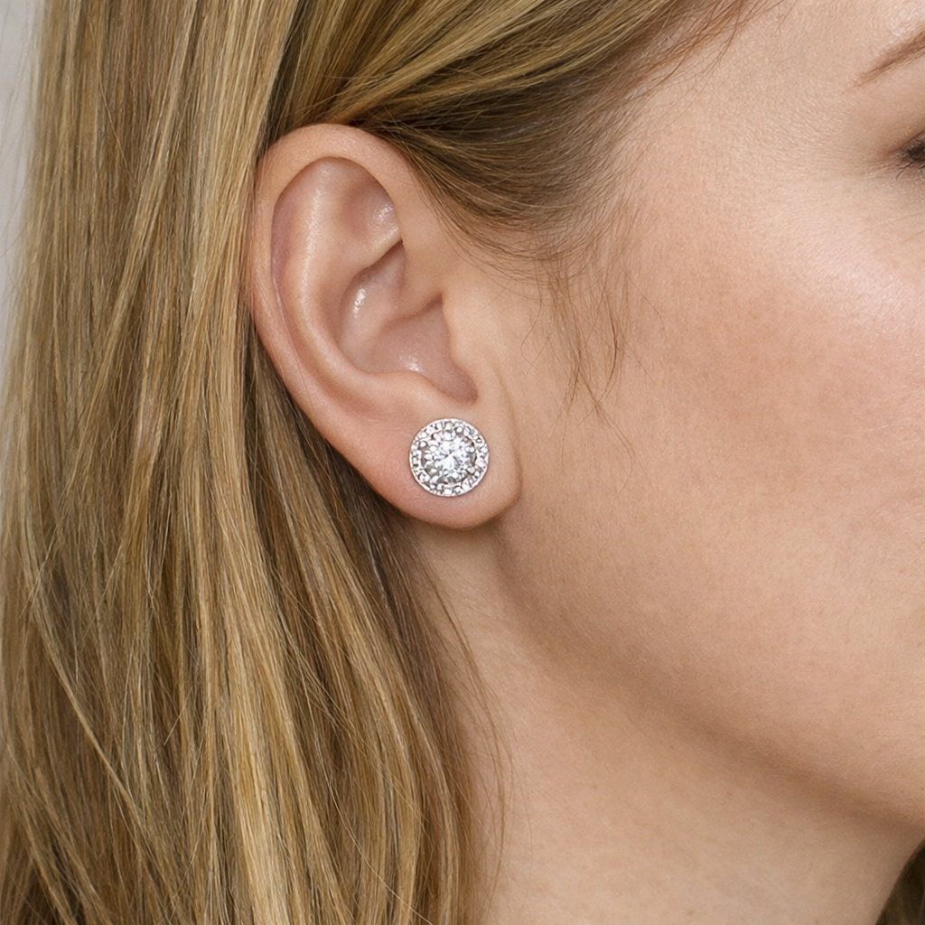 woman wearing stud aria silver round cut halo earrings by revert